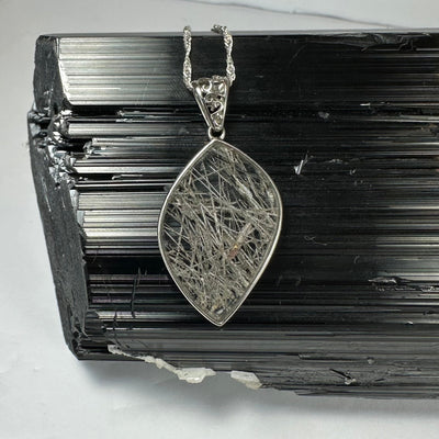 Close-up view of Rutilated Quartz Flame Pendant with silver clasp