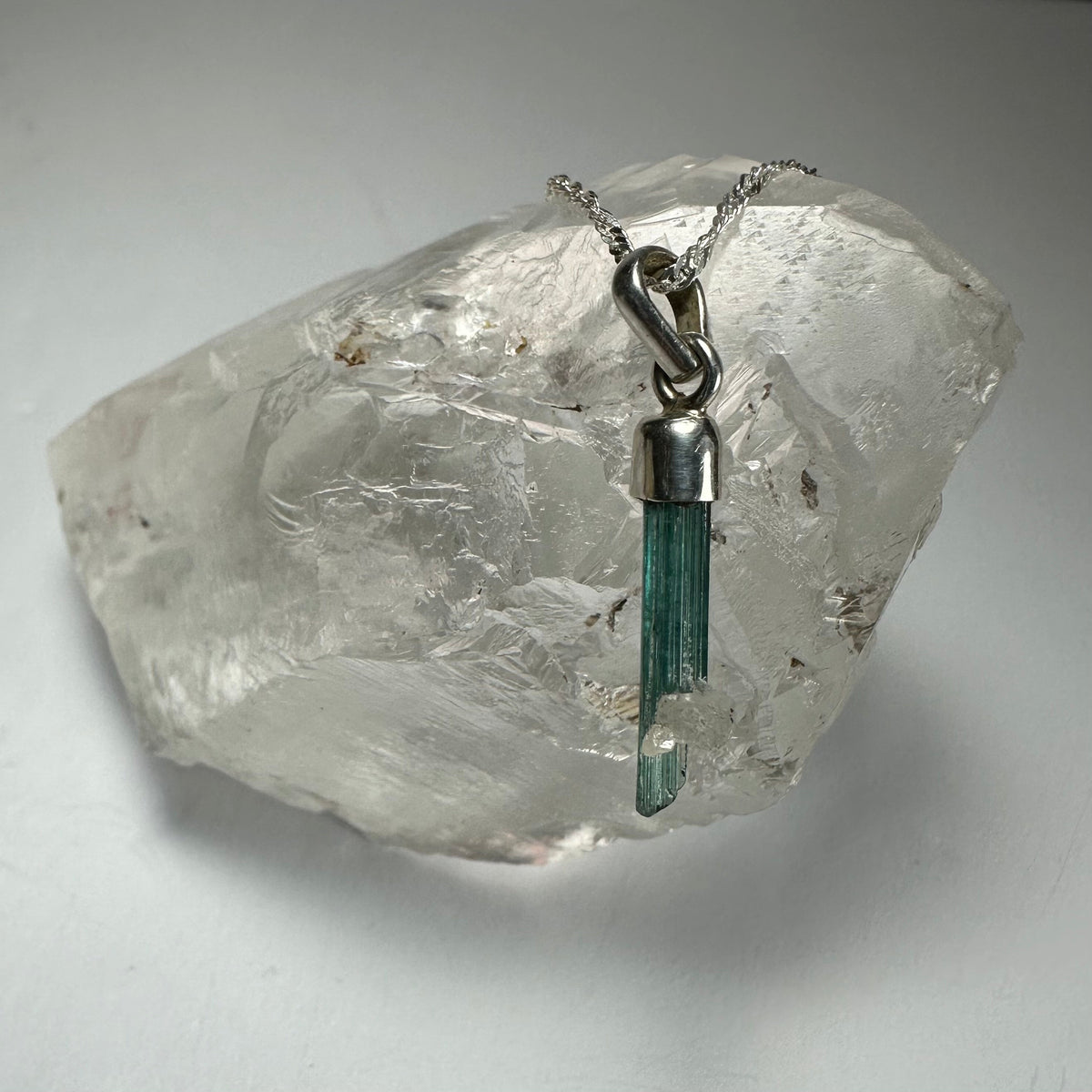 Natural Tourmaline Pencil Pendant in sterling silver setting with varied crystal coloration