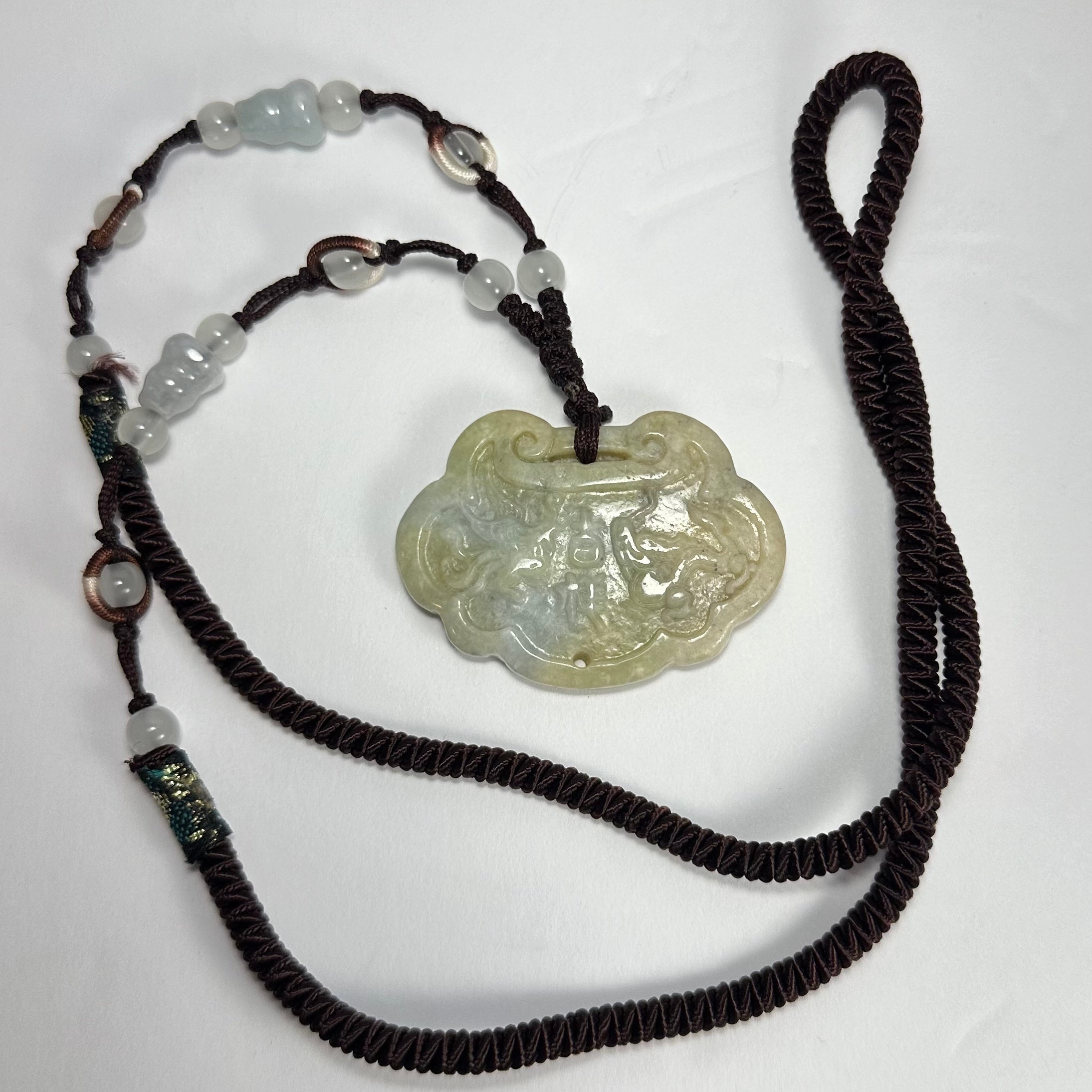 Dragon & Phoenix Nephrite Jade Necklace showing jade pendant with dragon and phoenix motifs on a 14.5-inch cord