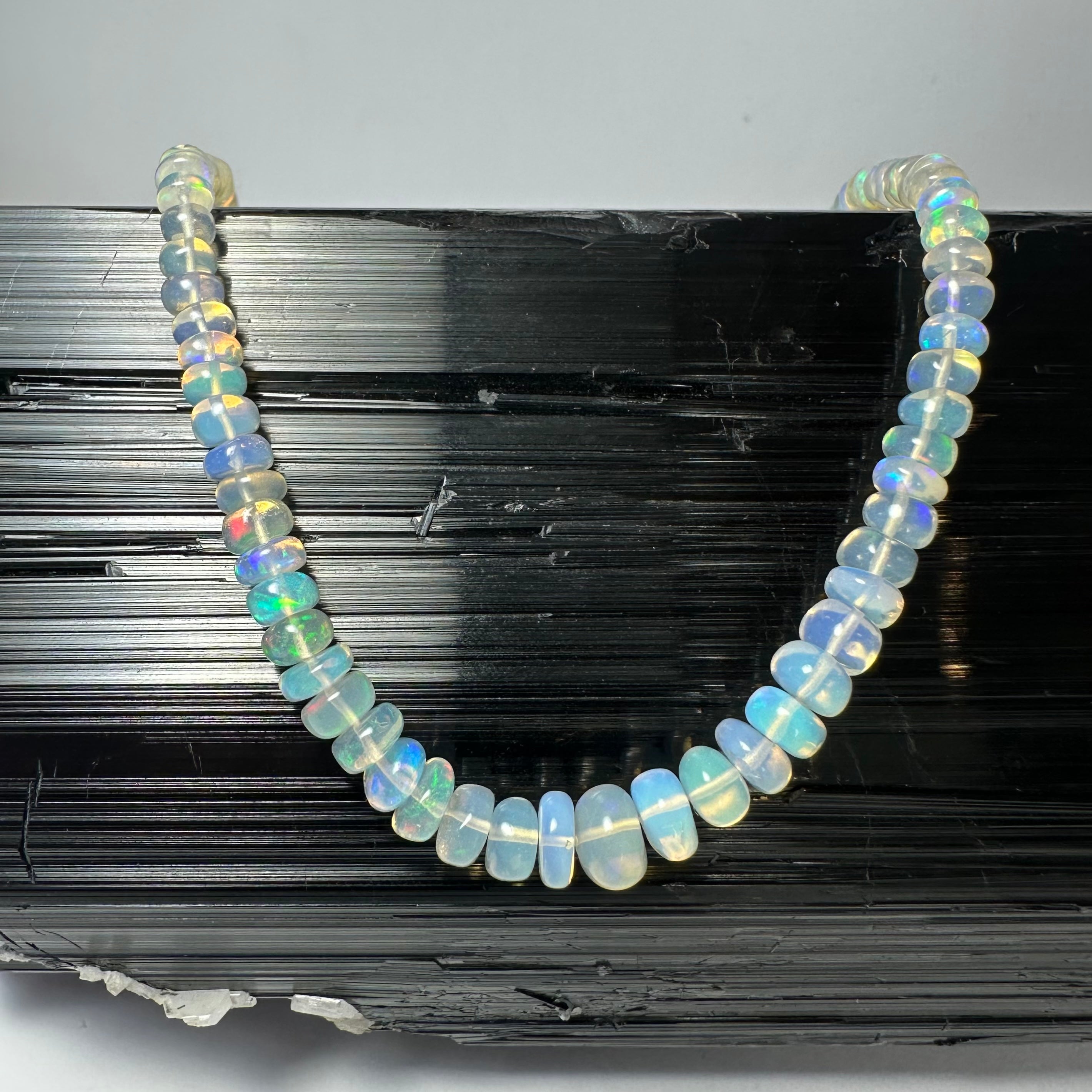 Welo Opal Graduated Bead Necklace from Ethiopia showing translucent opal beads on a white background
