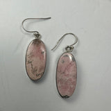 Close-up image of Rhodonite Earrings in diamond and oblong shapes with silver clasps