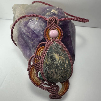 Close-up of Handmade Rhodonite Macrame Necklace showing braided cord and pink stone pendant