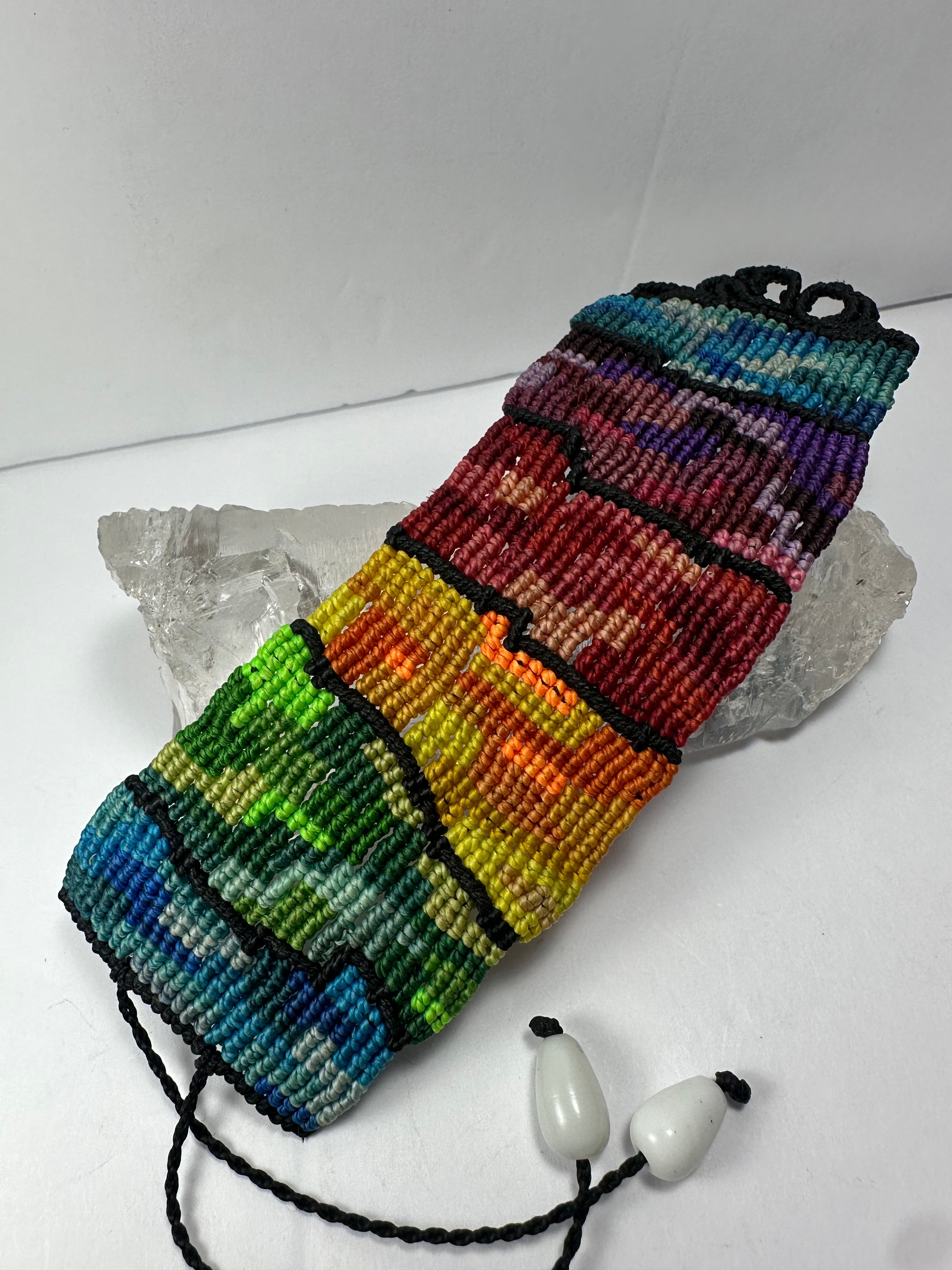 Hand Woven Rainbow Bracelet displayed on a neutral surface