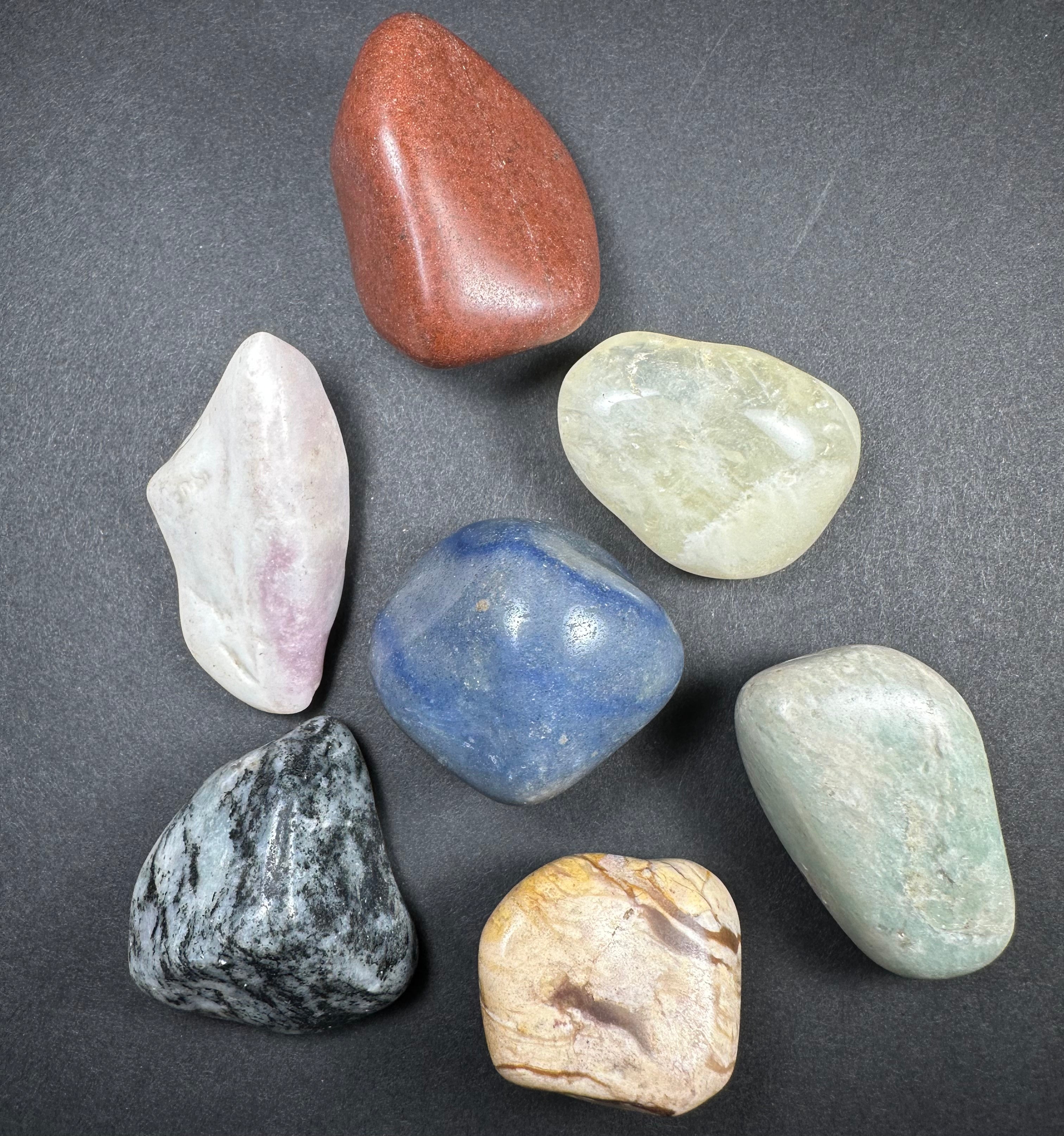 Assorted large tumbled stones of various mineral types including Tiger Eye and Chevron Amethyst