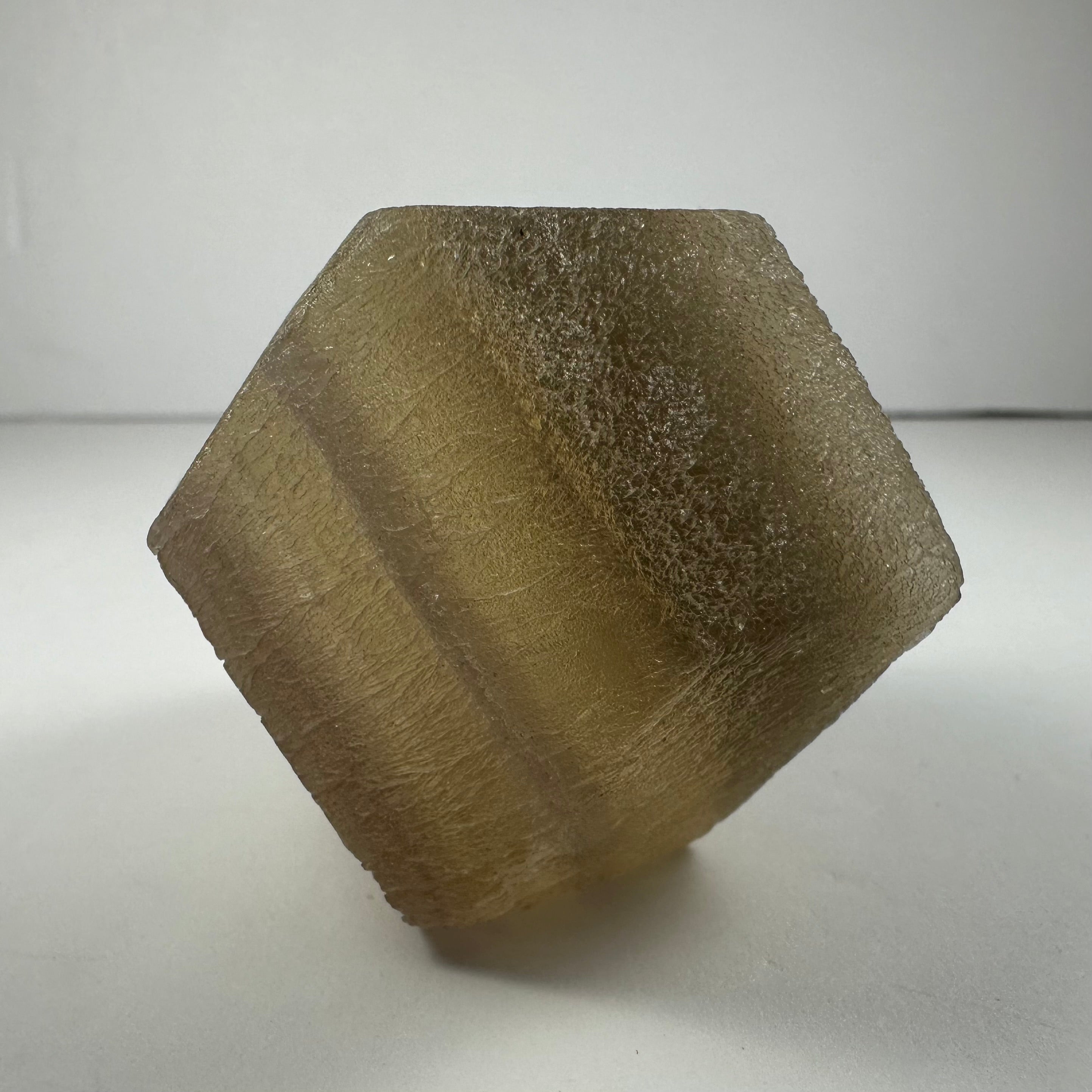 Fluorite dodecahedron mineral specimens in Yellow Banded and Purple Banded varieties, displayed on white background