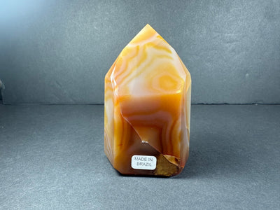 Polished banded carnelian tower from Brazil, showing orange and red color bands