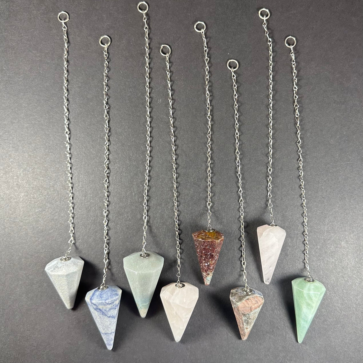 Stone Pendulum with Chain displayed on a neutral textured surface