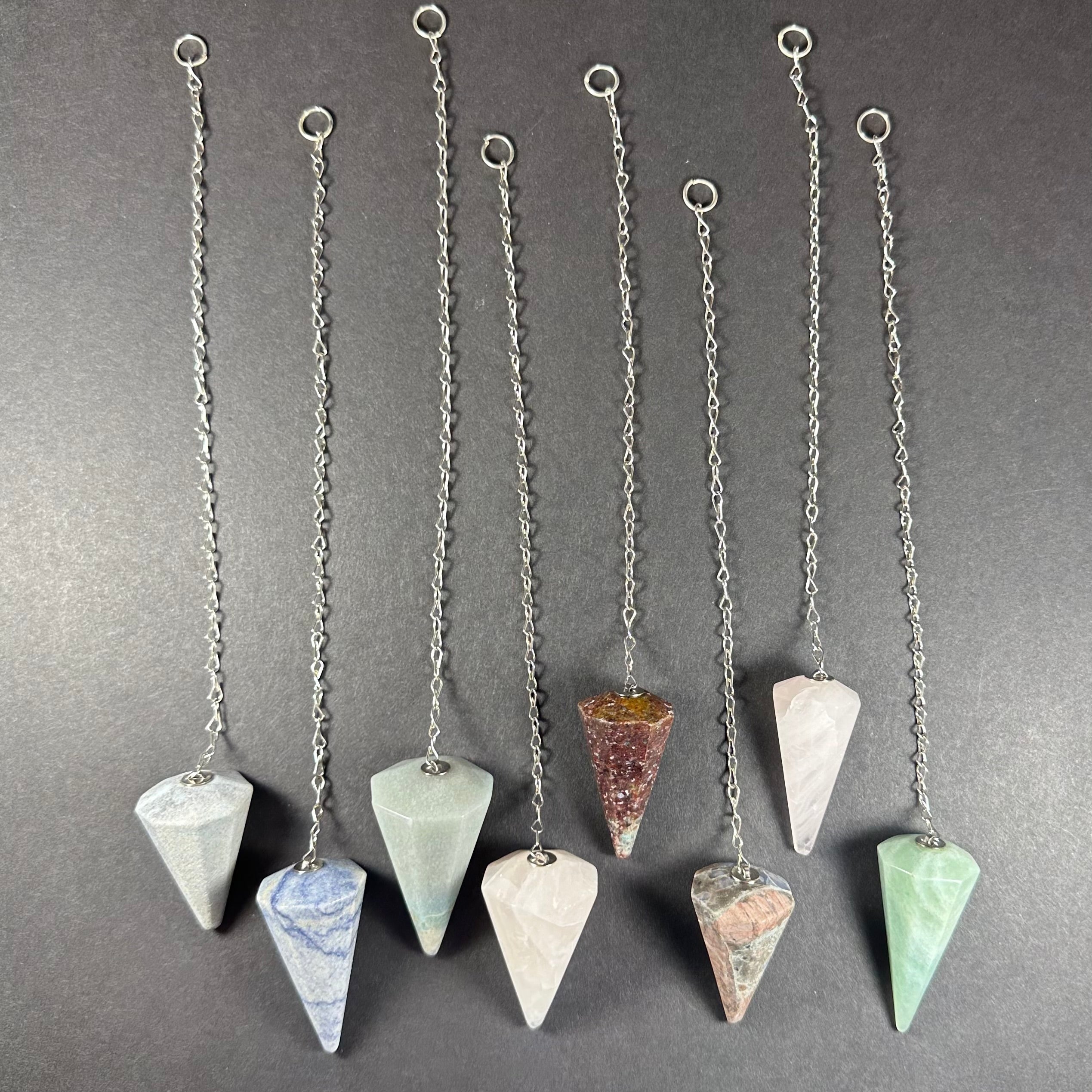 Stone Pendulum with Chain displayed on a neutral textured surface