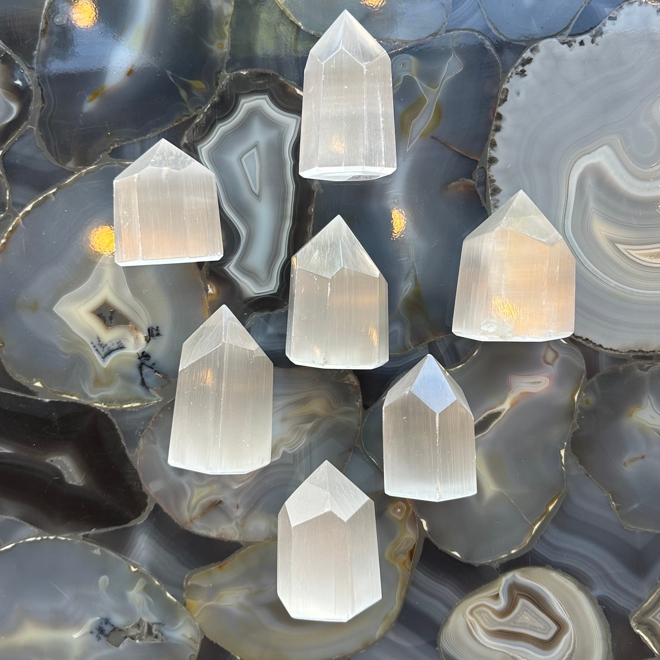 Selenite obelisk figurine from Morocco with a square base and translucent white crystal surface