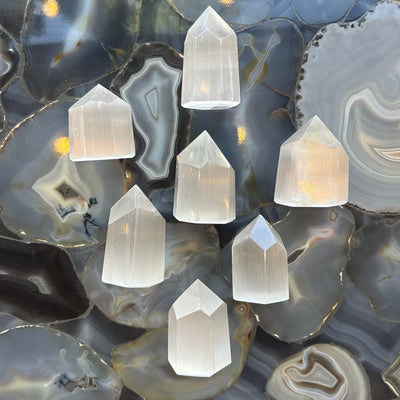 Selenite obelisk figurine from Morocco with a square base and translucent white crystal surface