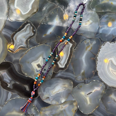 Amethyst Mala with Mixed Stone Beads laid out in a circular arrangement on a white background