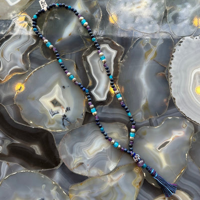 Lapis Lazuli Mala with Mixed Stone Beads displayed on a neutral textile