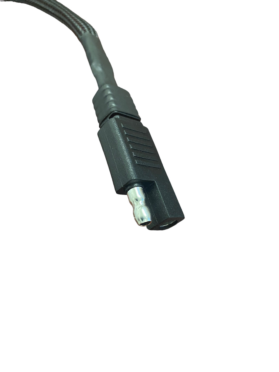 Close-up of a black dual Deutsch connector cable end with ribbed textured grip and silver metal pin, set against a white background.