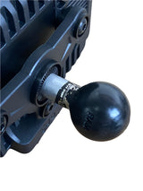 Close-up of a black TrailVue roll cage mounting ball attached to a metal bracket with visible wear marks on the silver connecting piece.