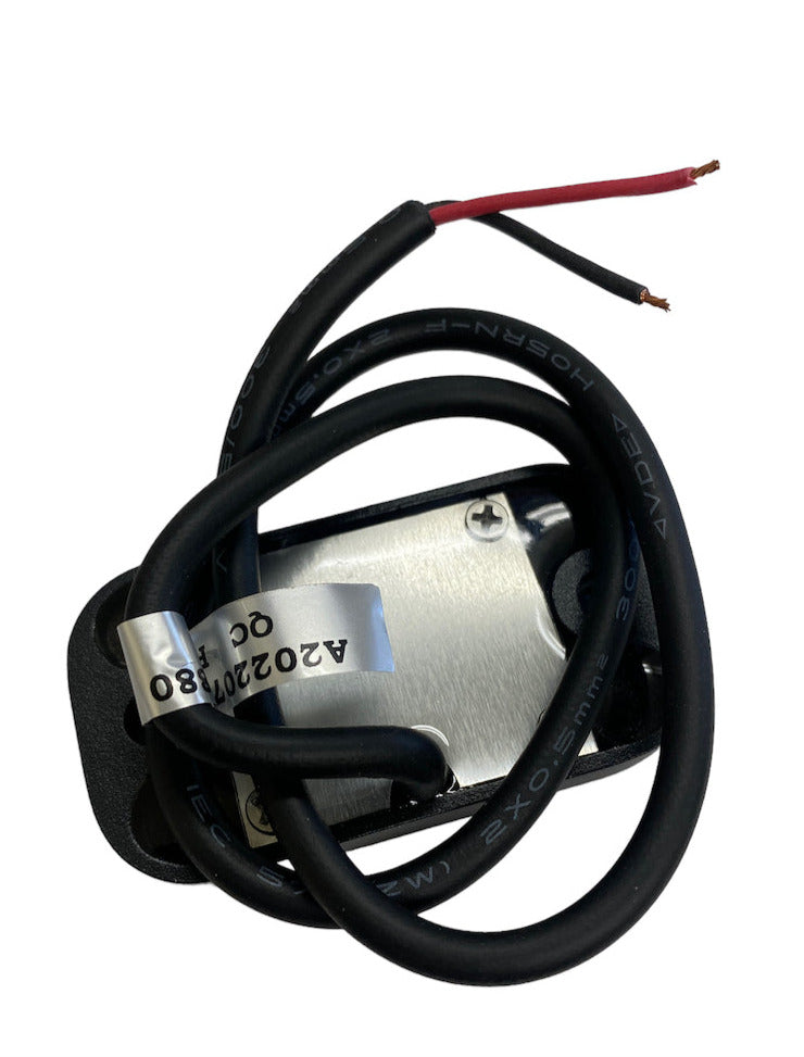 Black and red electrical wires coiled around a square metal LED rock light housing with a mounting bracket underneath.