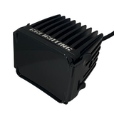Black square LED pod light with cooling fins on top and sides, featuring a smooth dark lens cover and white GS Lighting logo on the top finned surface.