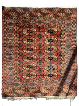 Vintage Tribal Turkoman Tekke Rug spread out displaying intricate tribal patterns in natural light