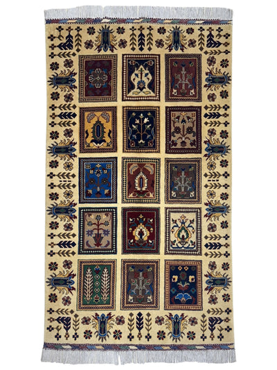 Hand-knotted Afghani Bakhteiari cream wool rug laid on wood flooring