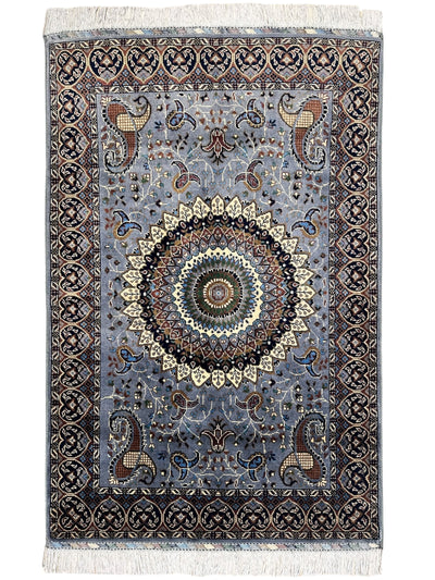 Hand-knotted gray Parak rug with geometric patterns, laid on wooden floor