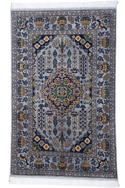 Hand-knotted Afghani Zerkhaki wool rug in silver tones, laid flat showing detailed pattern