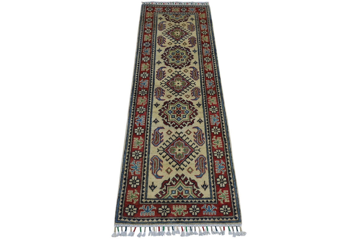 Rectangular hand-knotted Afghani Kazak wool rug with geometric medallions on a cream field and a red border featuring floral and tribal motifs, finished with fringe.