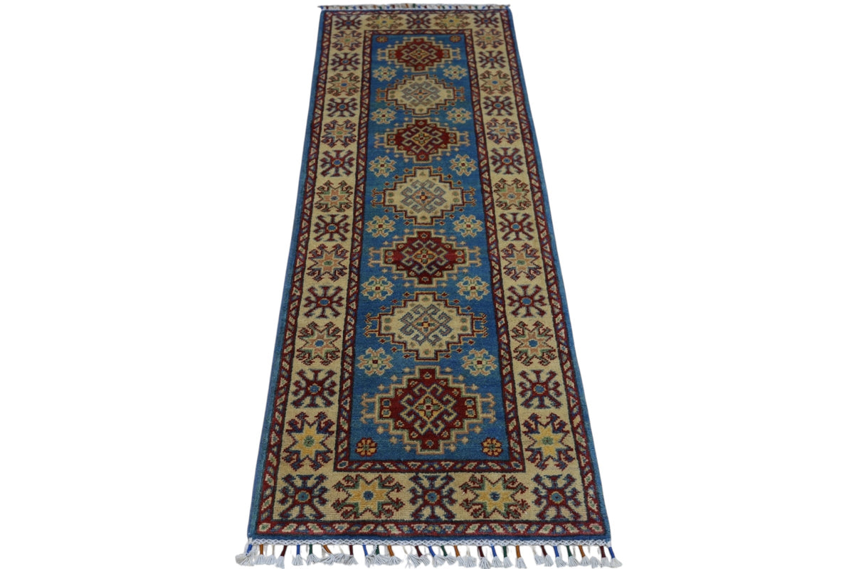 Hand-knotted Afghani Kazak wool rug with geometric patterns in red, blue, and beige, featuring a central medallion design and fringed edges.