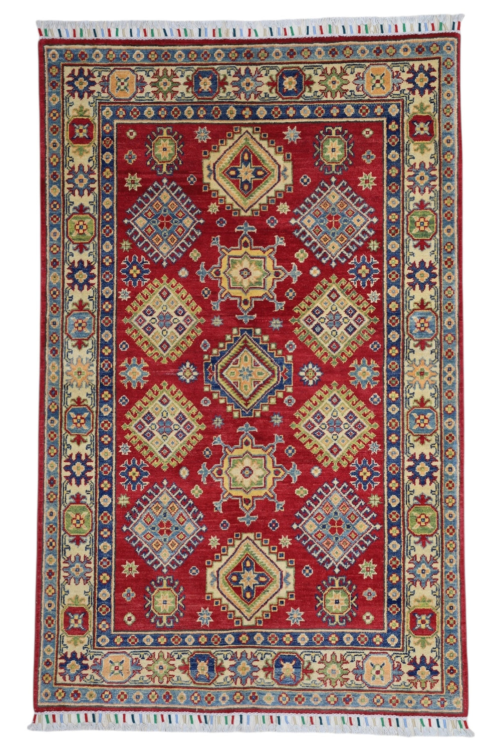 Hand-knotted Afghani Kazak wool rug in red with intricate geometric patterns, laid on wooden floor