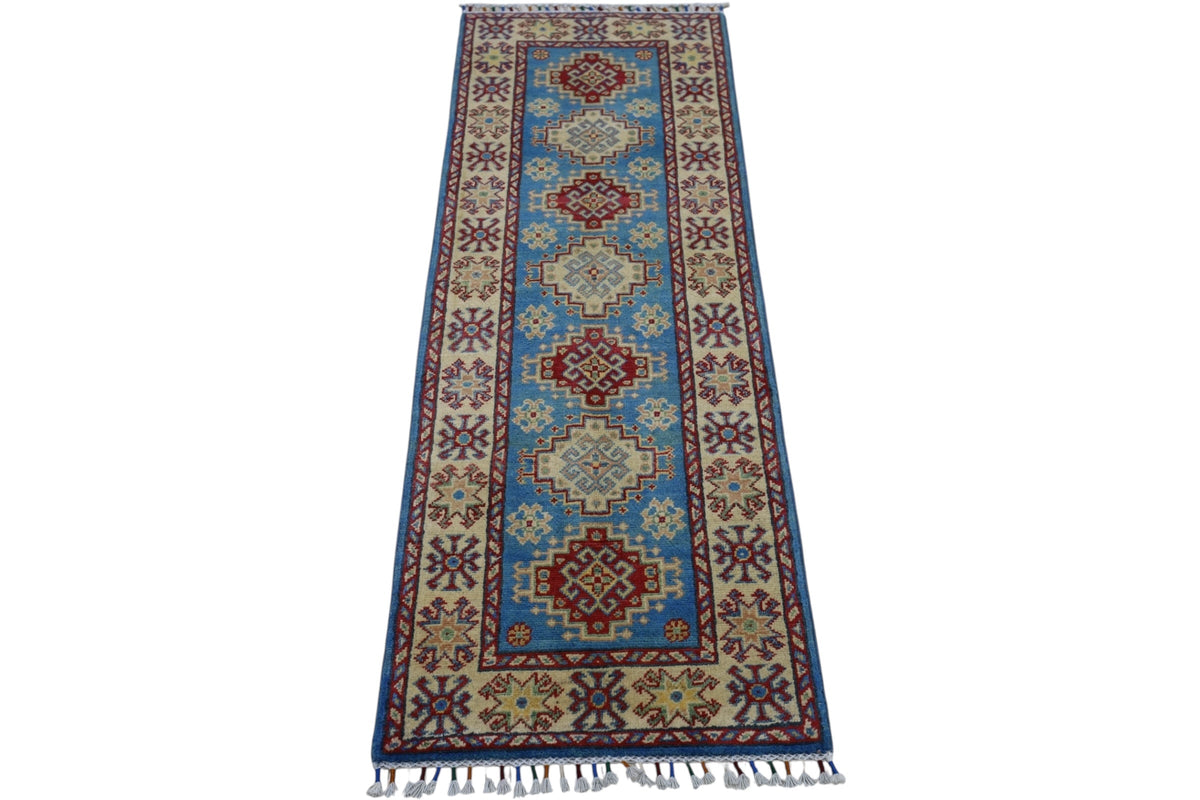 A narrow, hand-knotted Afghani Kazak wool runner rug featuring a central blue field with alternating red and cream geometric medallions, framed by a cream border with red and blue star motifs.