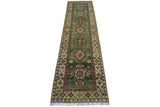 Long narrow hand-knotted Afghan Kazak wool rug with a green field, geometric medallions, floral motifs, and cream borders with intricate patterns and tassels.
