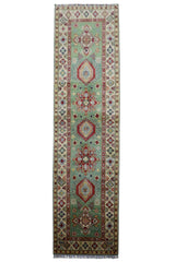 Hand-knotted Afghani Kazak wool rug featuring pistachio and red, sized 2’9″ x 9’2″, laid on floor