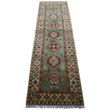 Long narrow Afghani Kazak wool rug with a muted green center featuring five geometric medallions in red, beige, and blue, framed by intricate beige and multicolored borders.