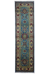 Hand-knotted Afghani Kazak wool rug in blue and cream laid on wooden floor