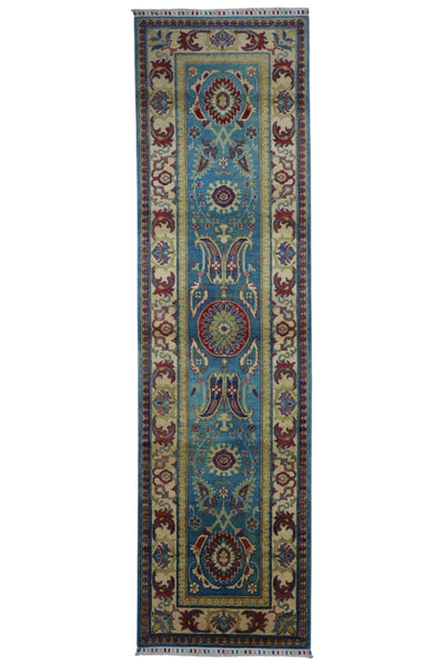 Hand-knotted Afghani Kazak wool rug in blue and cream laid on wooden floor