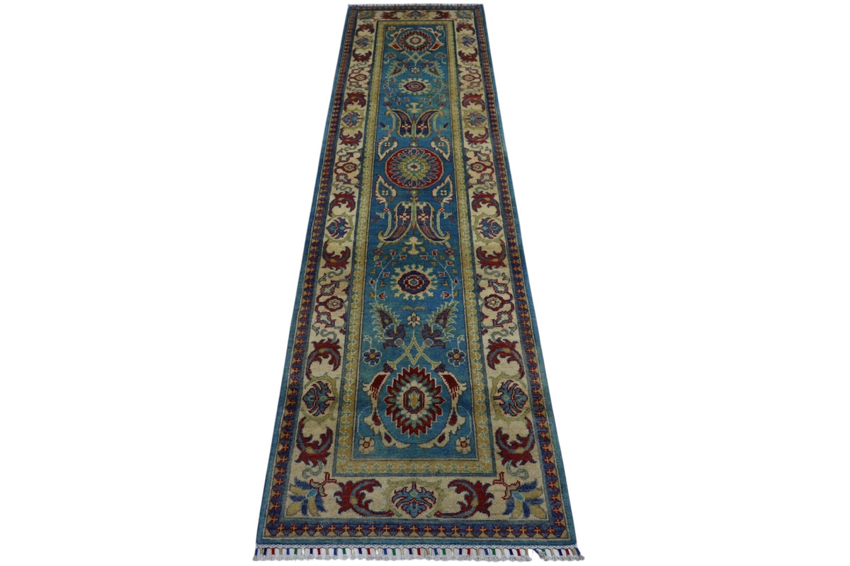 Long narrow hand-knotted Afghani Kazak wool rug with a teal central field decorated with symmetrical floral and medallion motifs, framed by cream and burgundy floral borders.