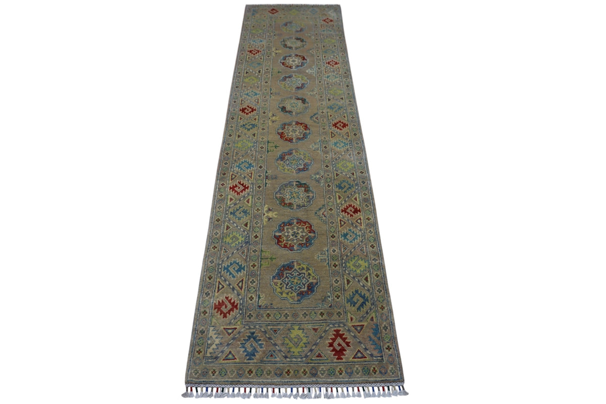 Long narrow hand-knotted Afghani Kazak wool rug with muted gray background, geometric medallions, multicolored accents, and fringes on one end.