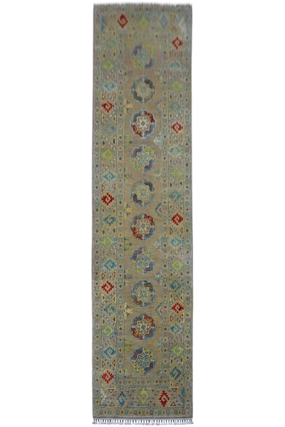 Hand-knotted Afghani Kazak wool runner rug in pistachio color, displayed on wood flooring