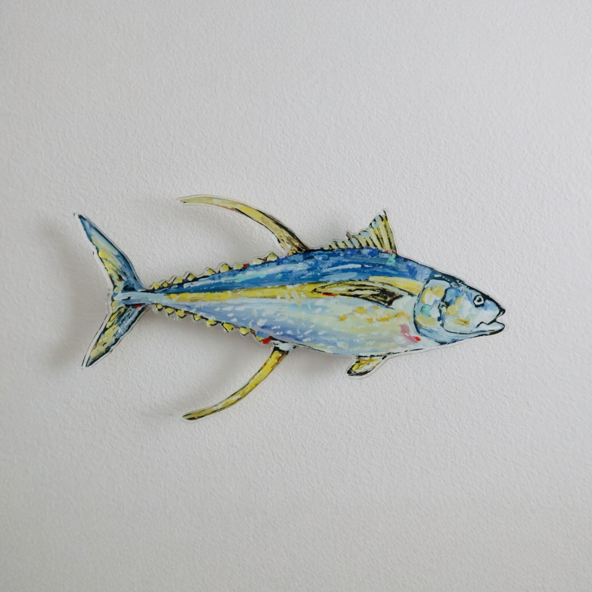 The "Tuna" Acrylic Wall Contour by Chelsea McShane Art displayed on a white wall, showing bright colors and an abstract fish silhouette.