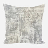 Square pillow with an abstract distressed pattern in shades of gray and off-white, creating a textured, weathered look on fabric.