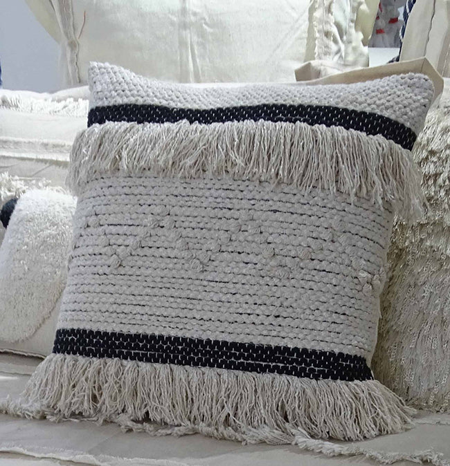Square throw pillow cover with black and beige horizontal stripes, tasseled edges, and textured woven pattern on a light fabric background.