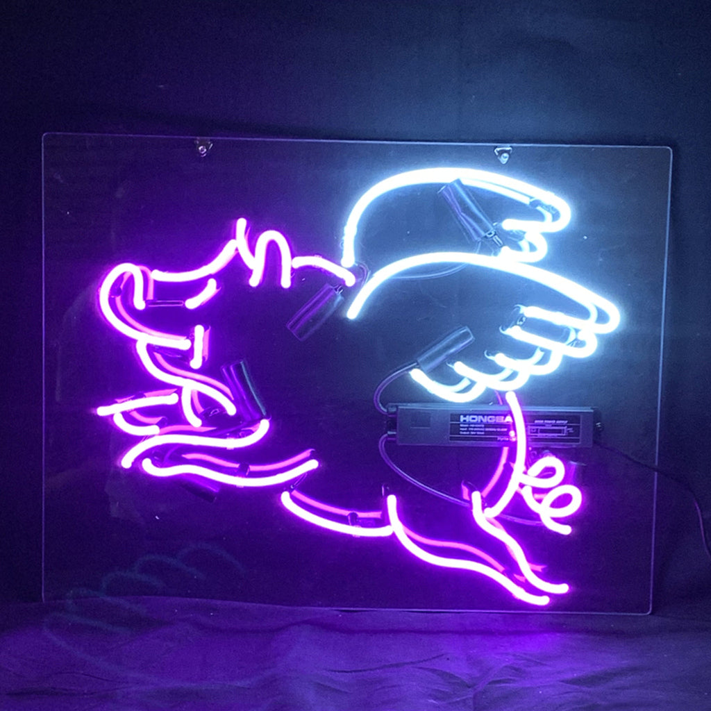 Purple Pig with Wings Neon Sign illuminated in a soft purple hue on acrylic backing