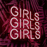 Bright pink neon sign spelling the word "GIRLS" three times stacked vertically against a patterned dark background.