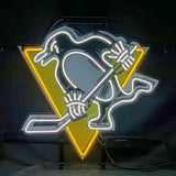 Neon sign of a stylized penguin holding a hockey stick in front of a yellow triangular background, with white and black neon outlines on a dark backdrop.