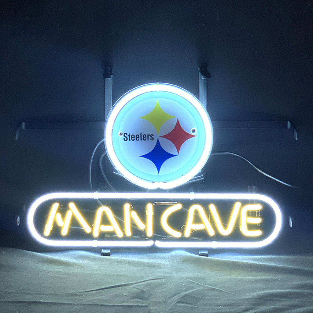 Bright neon sign spelling Pittsburgh Steelers Football Man Cave in yellow and white glass tubing on a black grid backing, illuminated against a dark wall.