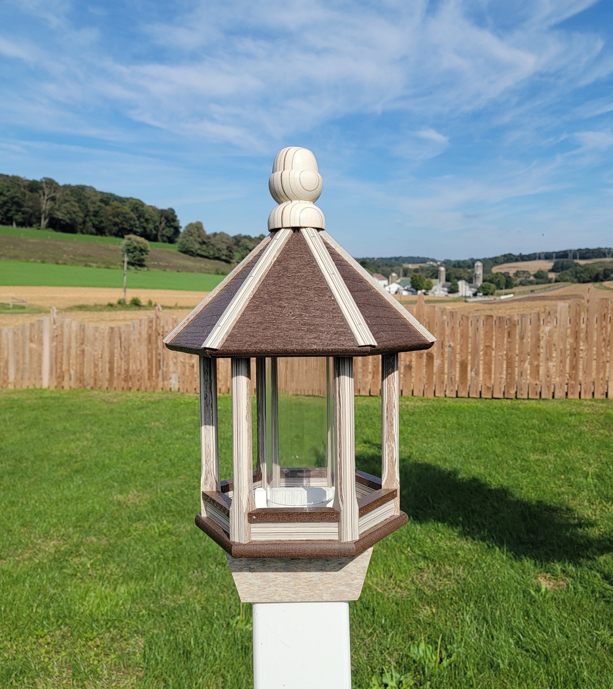 Amish handmade poly bird feeder with rustic spindle design, shown mounted outdoors