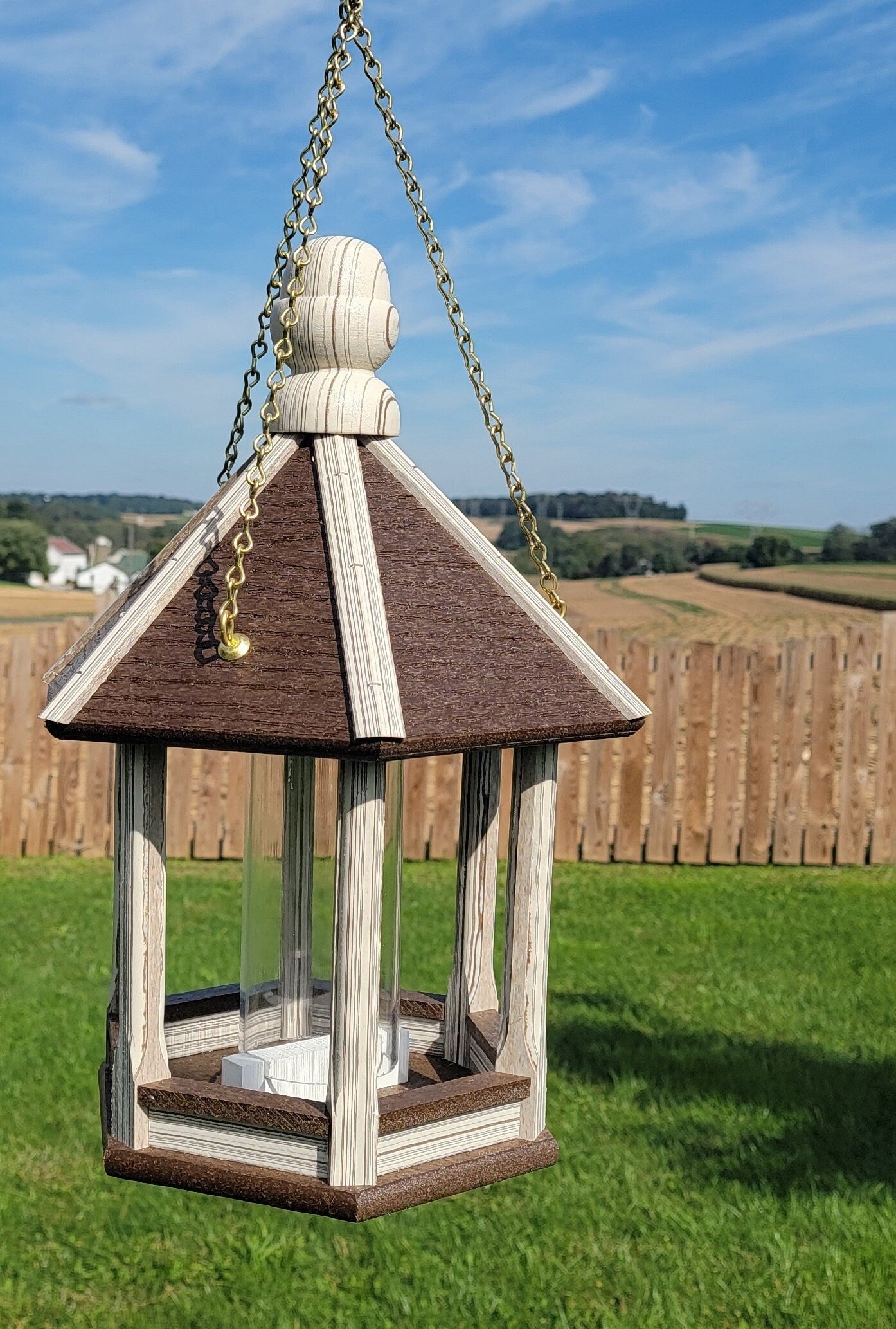 Amish handmade poly bird feeder with rustic spindle design, shown mounted outdoors