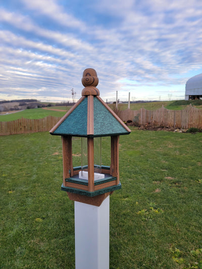 Amish handmade poly bird feeder with rustic spindle design, shown mounted outdoors