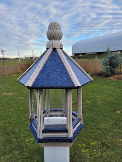 Amish handmade poly bird feeder with rustic spindle design, shown mounted outdoors