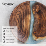 Round wooden board with natural wood grain and swirling blue resin river through the center, on a light gray textured background.