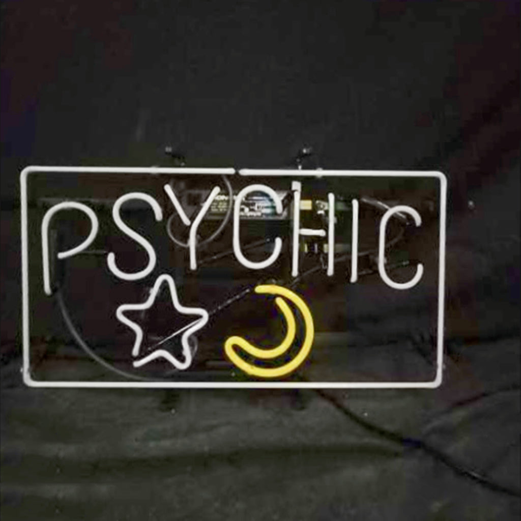 Rectangular neon sign with white letters spelling 'PSYCHIC' above a white star and a yellow crescent moon on a dark background.