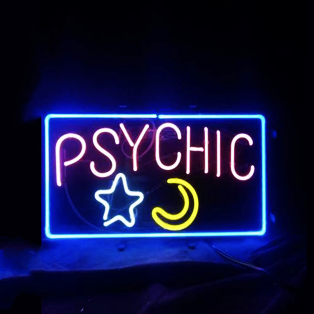 Rectangular neon sign with the word 'PSYCHIC' in pink, a white star and a yellow crescent moon, all outlined by a bright blue border against a dark background.